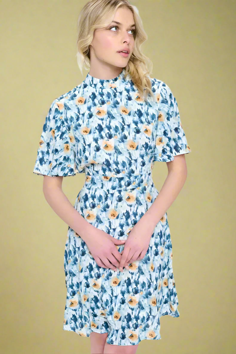 model is wearing a short sleeve dress with abstract print 