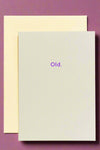 An off-white minimalist greeting card with small purple text that reads ‘Old.’