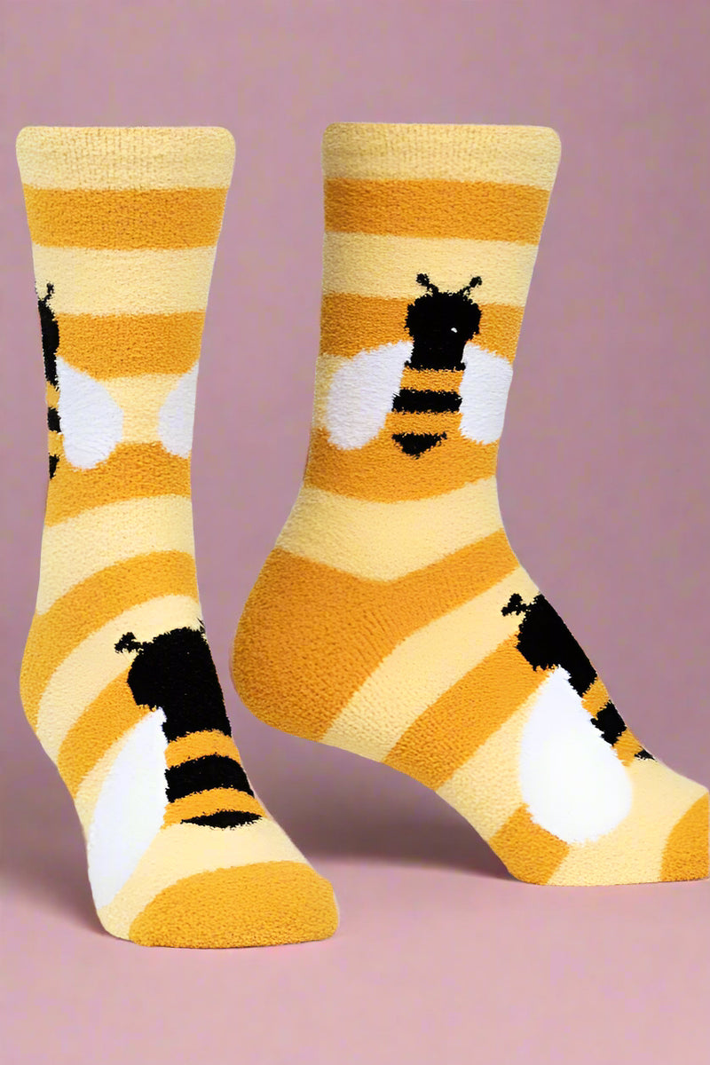 Pair of socks with bee design on a light gray background
