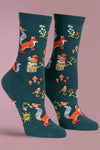 Pair of socks with fox and nature pattern on a light gray background