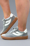 Grey soccer style sneakers that feature darker grey suede accent panels.