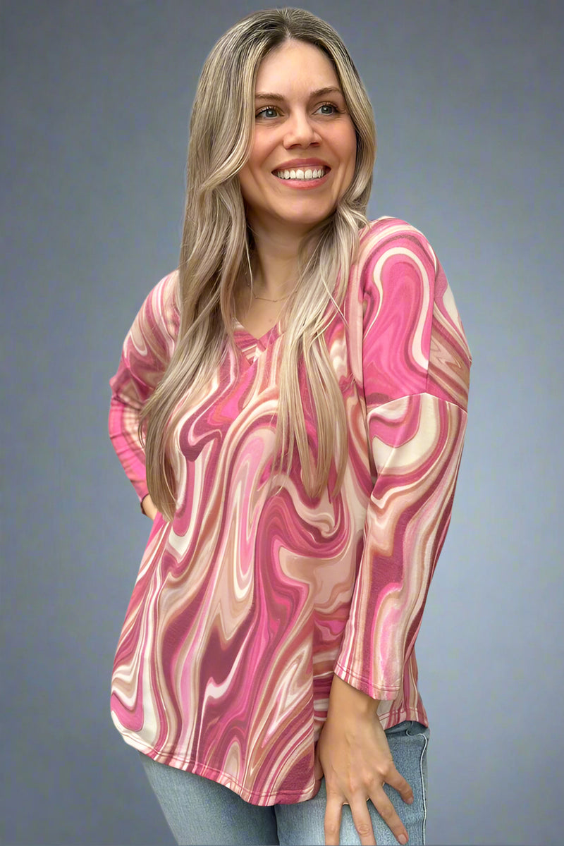 A 3/4 sleeve lightweight top. It features a pink swirl pattern and small v-neck.