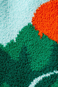 Close-up of a textured surface with green, blue, and orange colors.