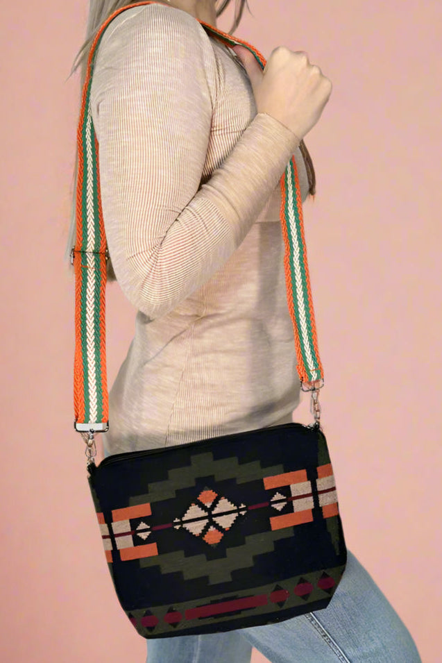 Model is wearing a small aztec printed crossbody. 