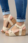 Cream studded cork wedge sandals with two adjustable straps and a comfortable footbed. 