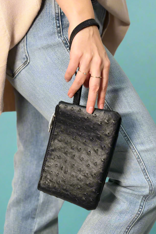 A faux ostrich wristlet. Comes in a black or mustard color.