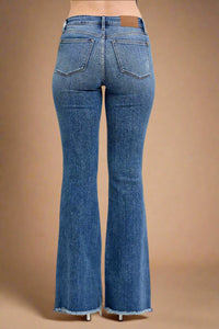 Blue flared jeans on a beige background
