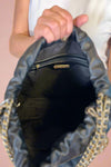 Large quilted black shoulder bag with chain strap. 