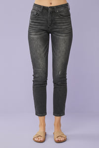 Black jeans worn by a person on a plain background