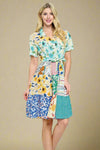 Model is wearing a patchwork dress. 