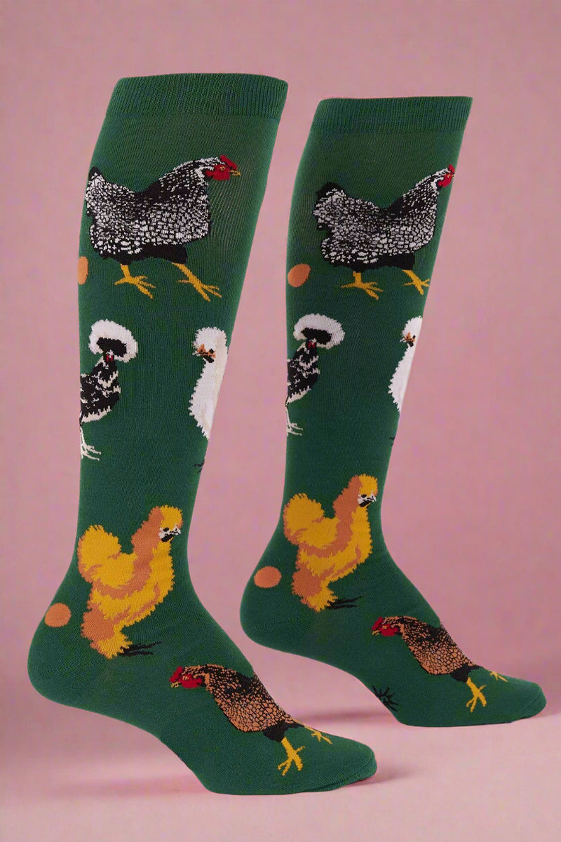 Green socks with chicken pattern on a white background