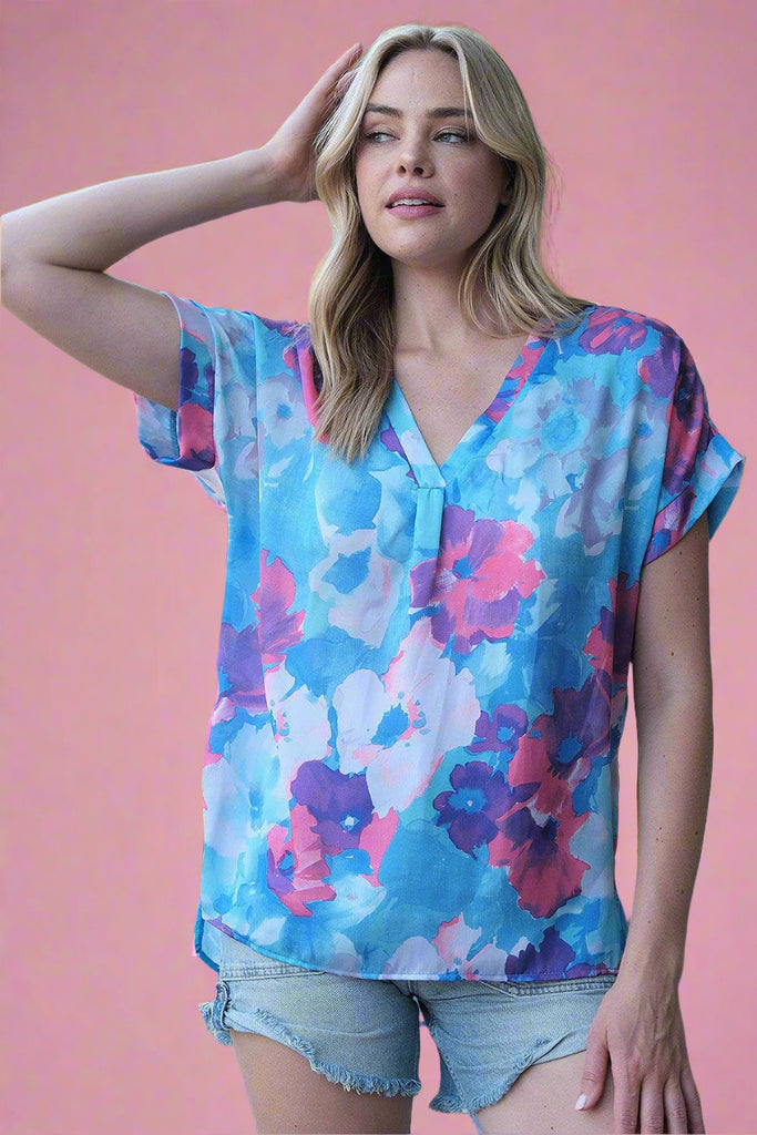 This is a lightweight, relaxed fit v-neck top features a blue and pink floral pattern.