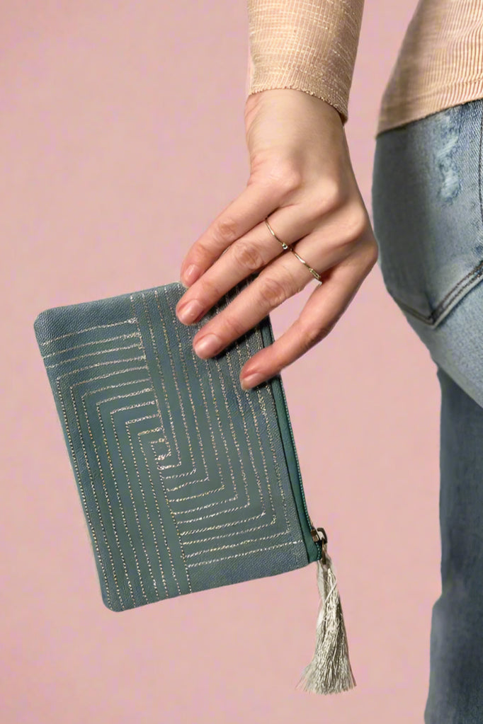 Model is holding a metallic coin purse.