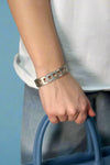 Silver bangle bracelet, rectangular shaped with square cut outs. 
