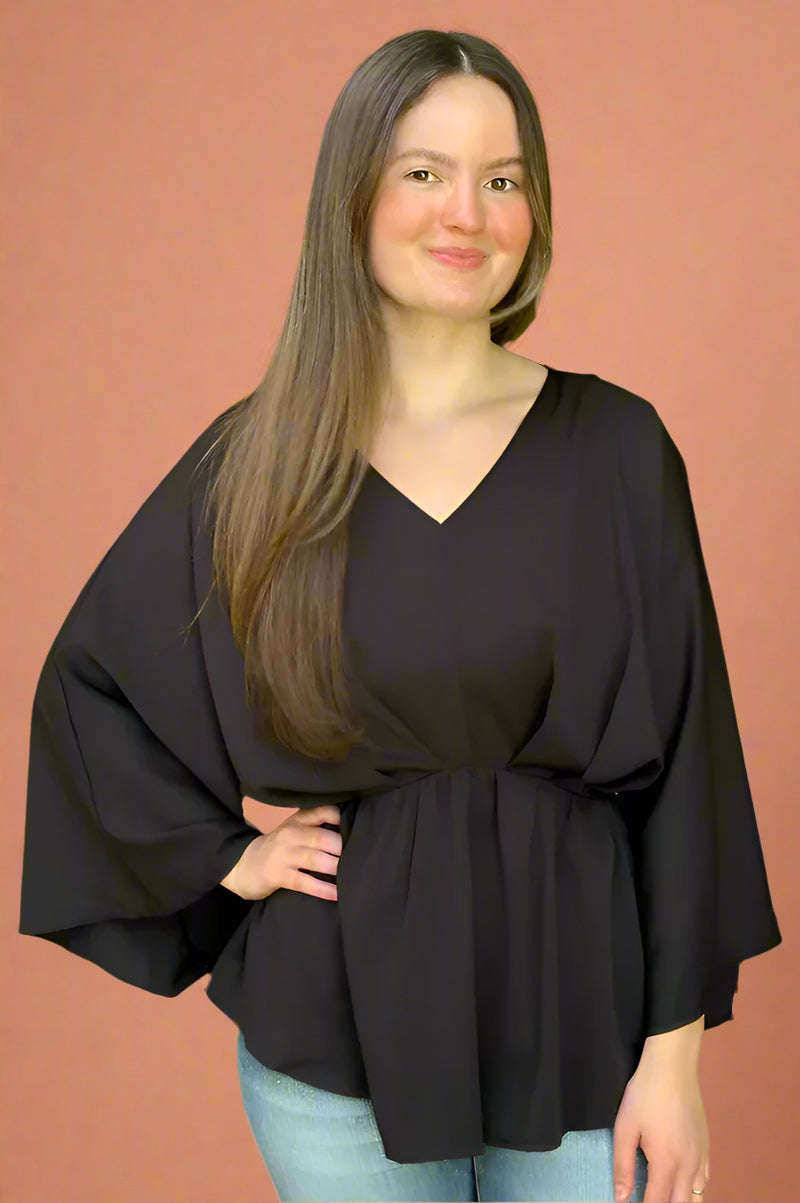 A black peplum top with 3/4 length sleeves and v-neck.