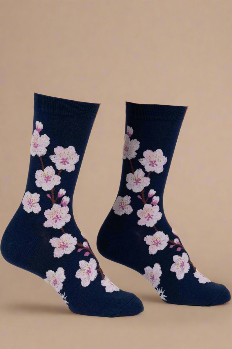 Navy socks with pink floral pattern on a white background