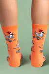 Orange socks with cartoon rooster designs on a white background