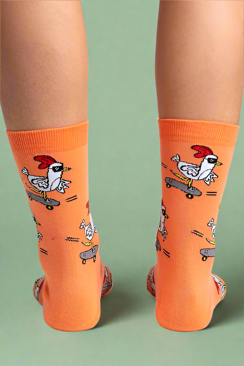 Orange socks with cartoon rooster designs on a white background