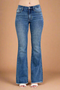 Blue flared jeans on a plain background.