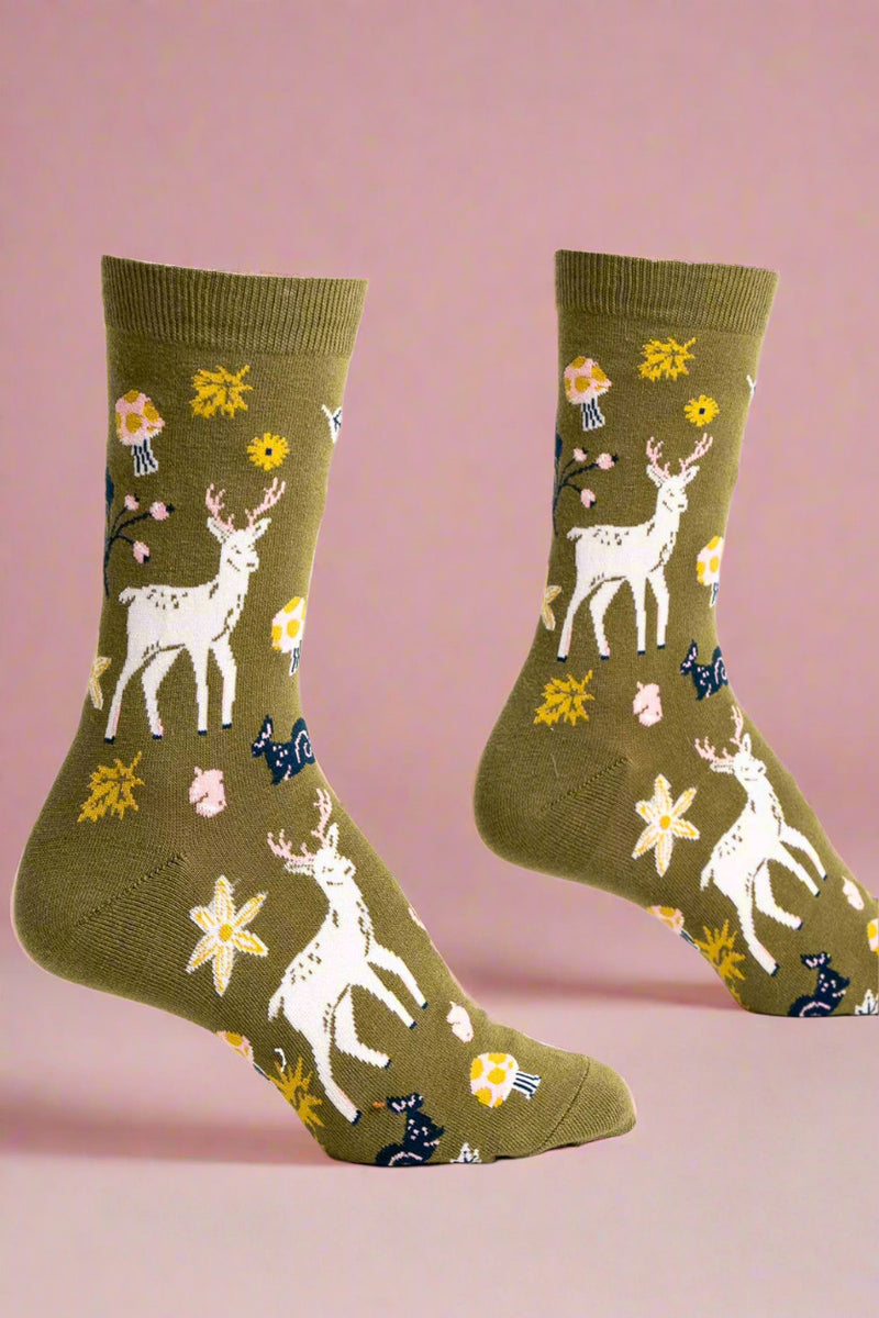 Pair of socks with deer and floral pattern on a green background
