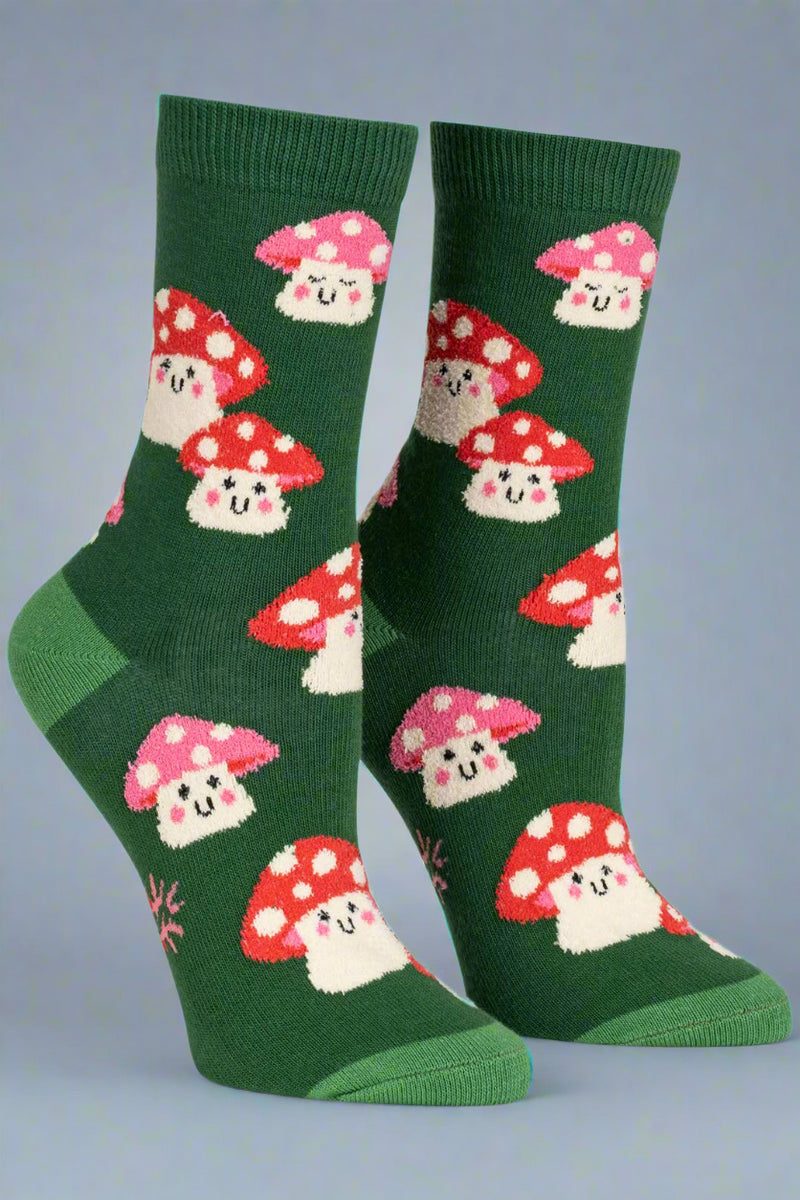 Green socks with mushroom pattern on a light gray background