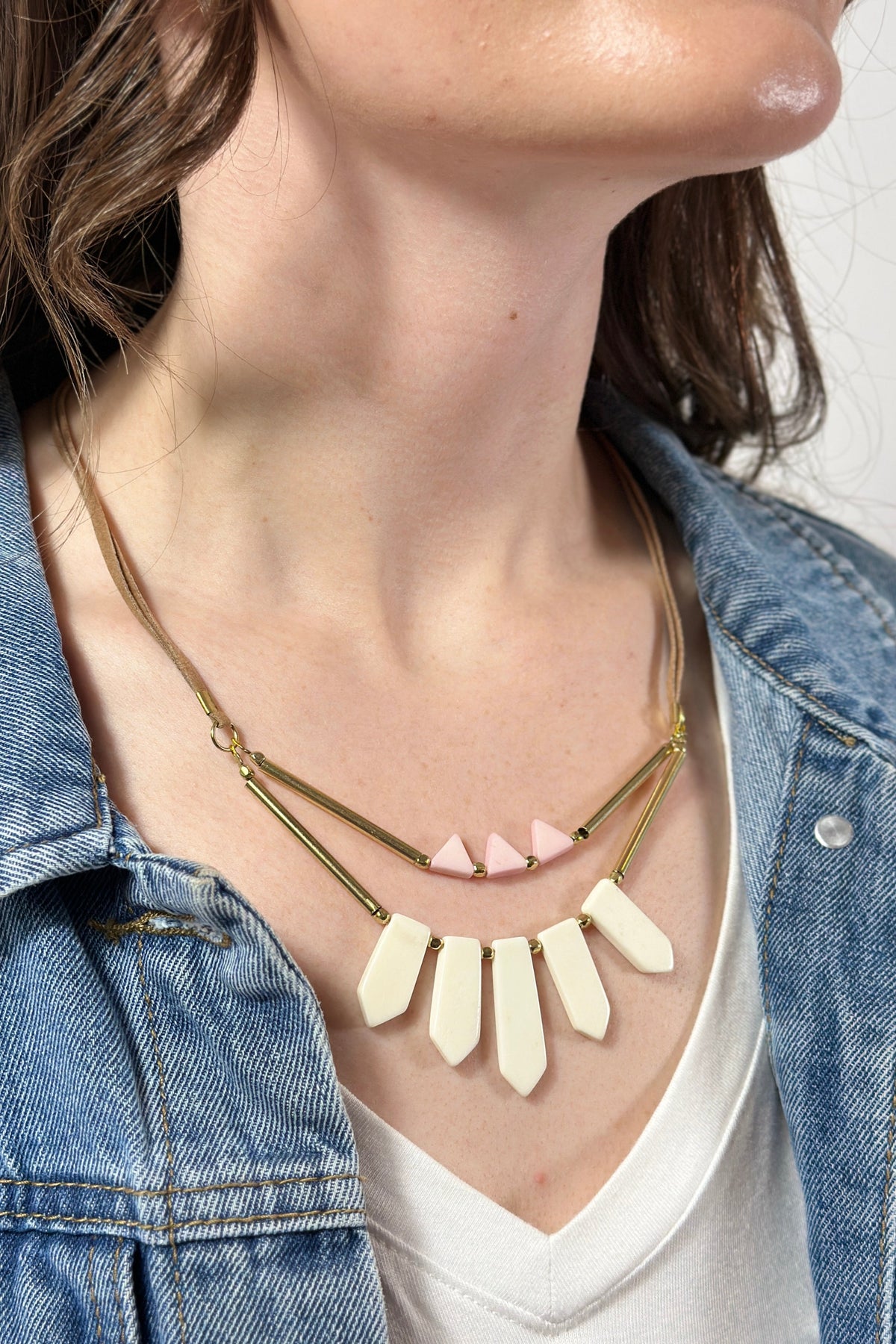 Model is wearing a fair trade necklace with bone statement pieces. 