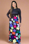 A long sleeved black maxi dress with colorful floral details.