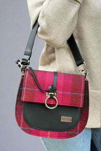 Plaid and black faux leather shoulder bag with removable crossbody strap and silver hardware. 