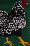Knitted rooster design on a green background