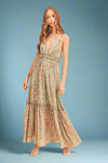 Woman wearing a green floral dress on a beige background