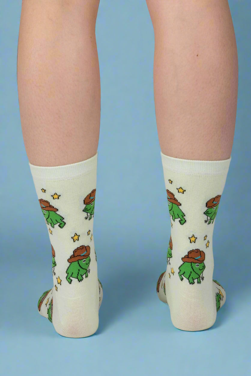 Light green socks with cartoon character design worn by a person on a plain background
