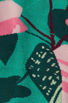Close-up of socks with pink and green floral design on a teal background