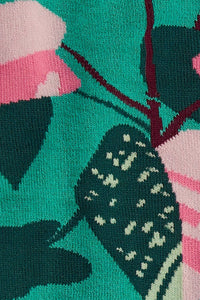 Close-up of socks with pink and green floral design on a teal background