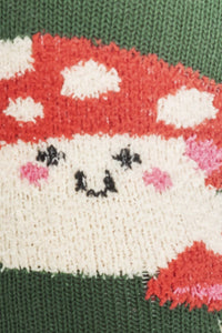 Knitted character with a red hat and white face on a green background