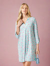 Woman wearing a floral nightshirt on a white background