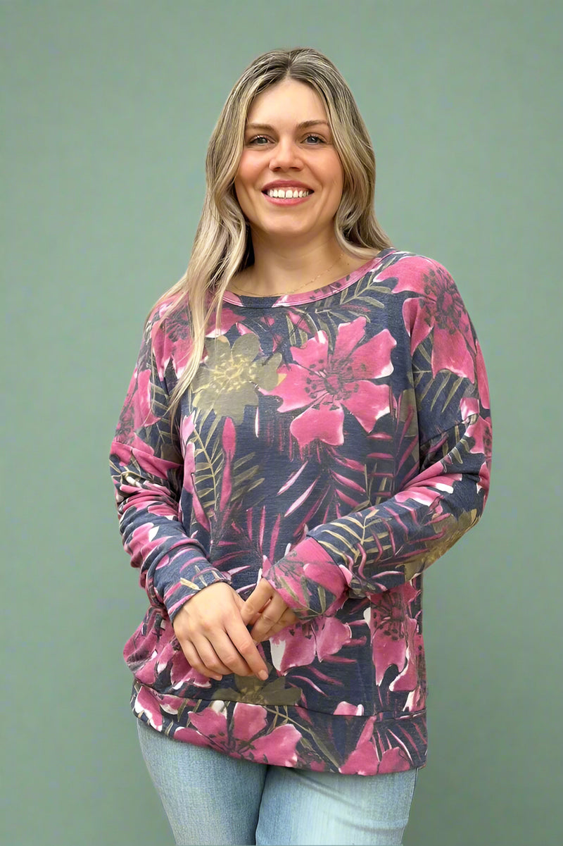 A women’s lightweight long sleeve top featuring a scoop neckline, banded hem and cuffs, and tropical floral print in pink and sage.