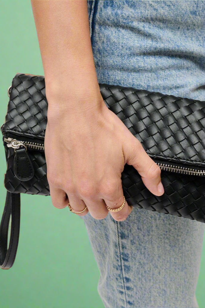 Small fold over flap clutch with woven vegan leather pattern. 