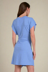Woman wearing a blue dress on a plain background