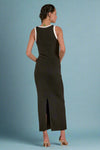 Woman wearing a black sleeveless dress with a slit on a white background