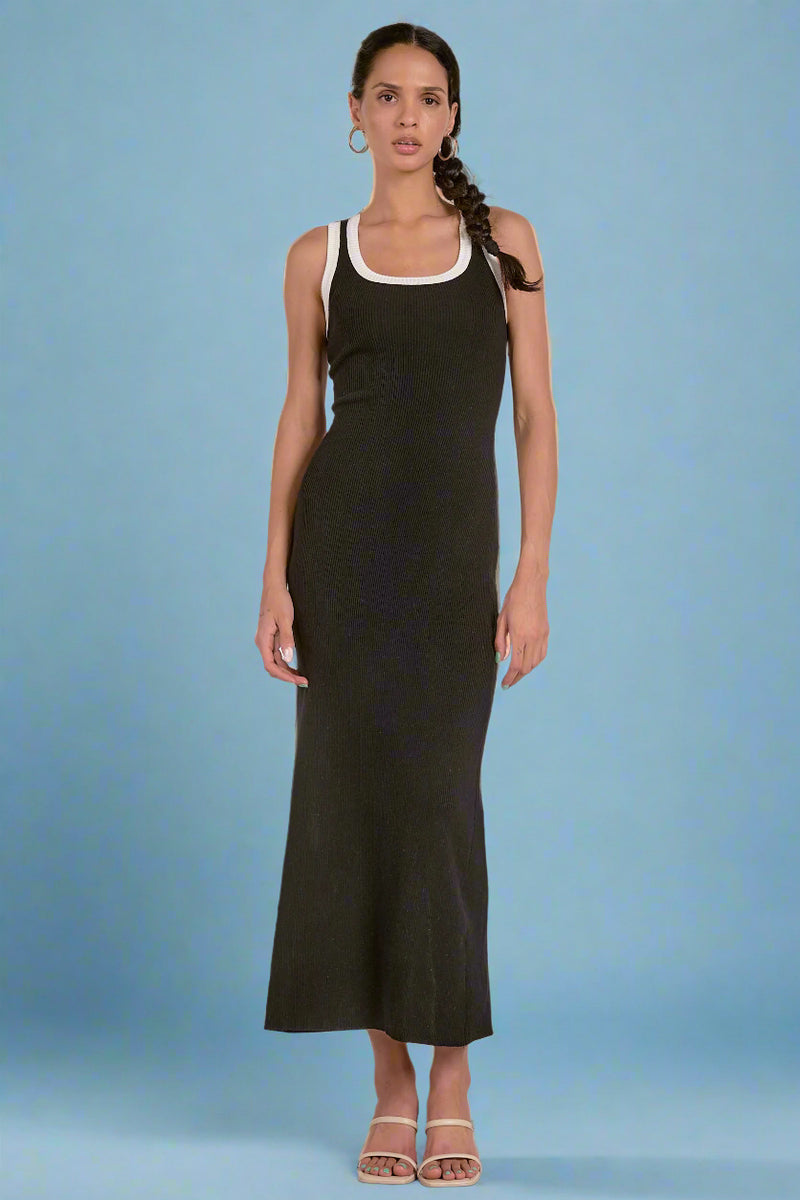 Woman wearing a black sleeveless dress against a white background