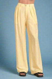 Yellow wide-leg pants worn by a person on a white background