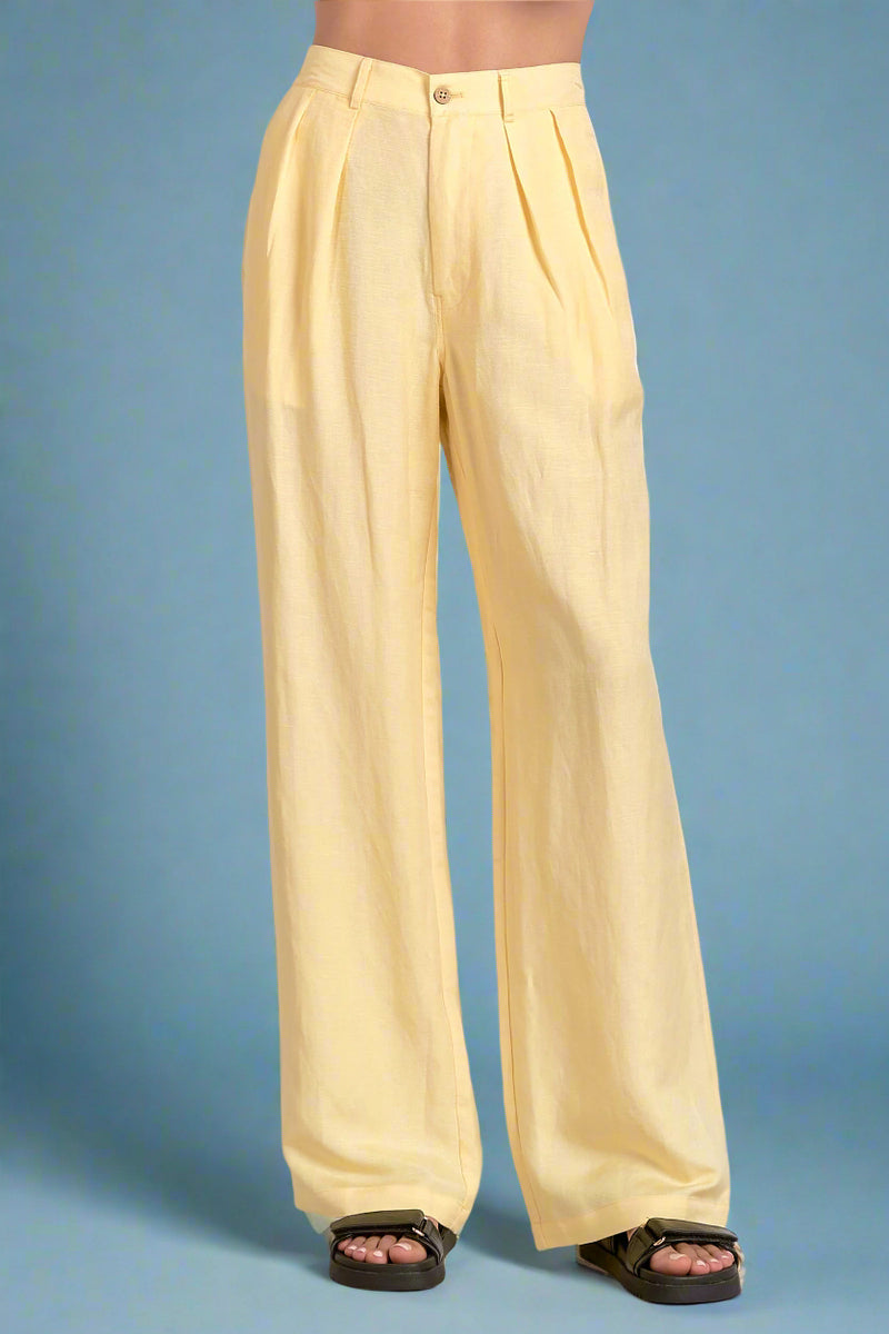 Yellow wide-leg pants worn by a person on a white background