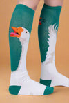 Knee-high socks with goose design on a plain background