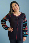 A black long balloon sleeve top with a tie front and red and turquoise embroidered details. 
