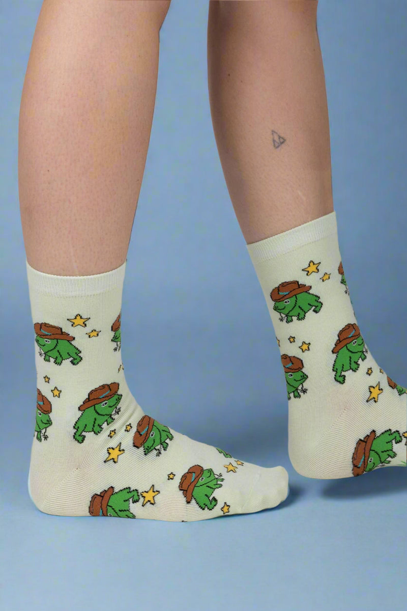 Light green socks with cartoon character design worn by a person on a plain background