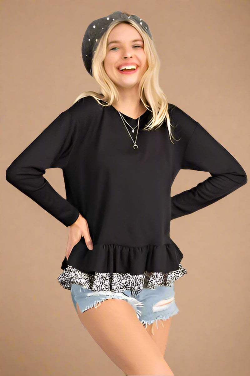 A womens relaxed fit, scoop neck long sleeve shirt with a ruffle hem in black featuring second ruffle under hem in black and white floral print.