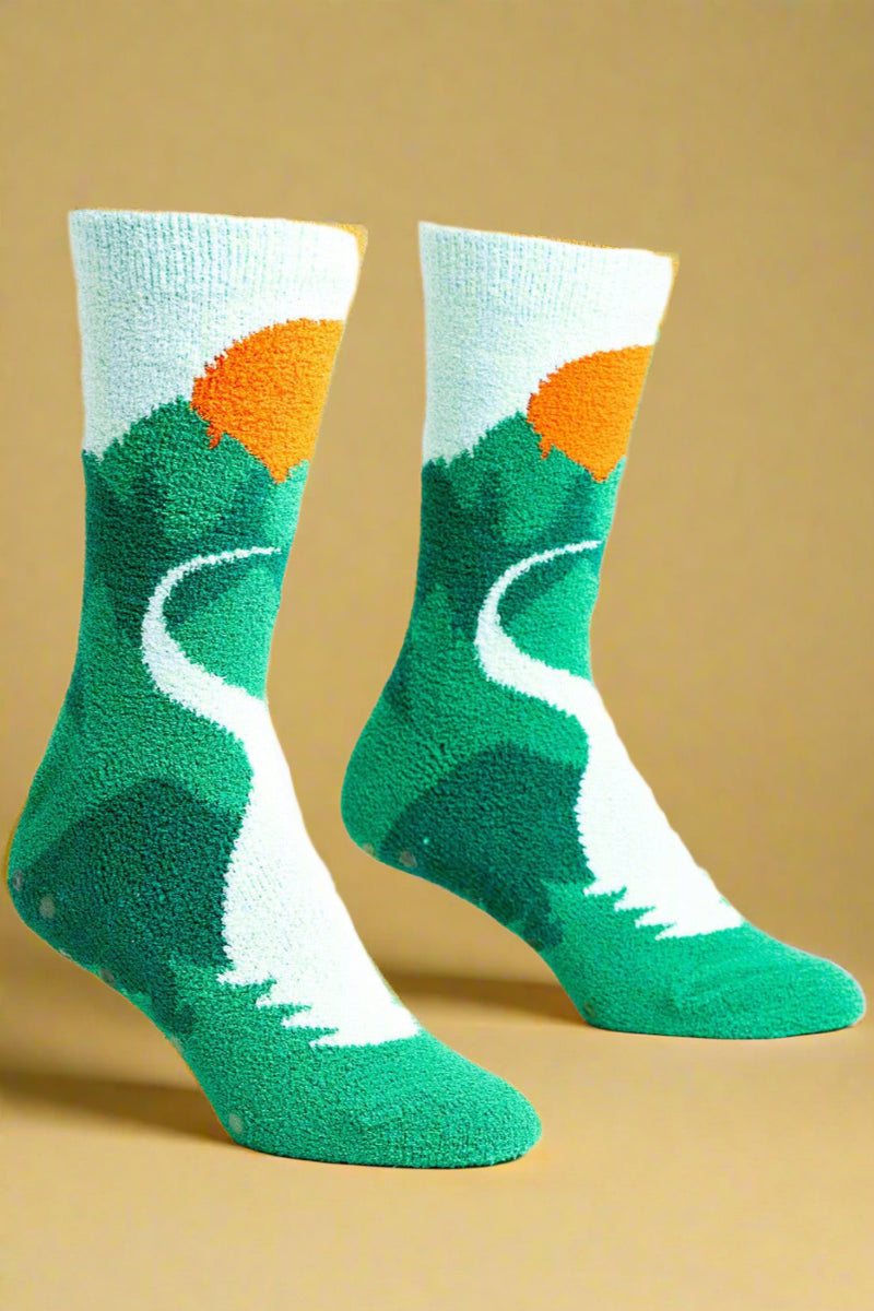 Green and orange socks with a nature-themed design on a white background