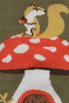 Squirrel on a red mushroom with white spots on a green background