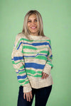 Model is wearing a wave printed crew neck long sleeve sweater with shades of blue, green, and beige. 