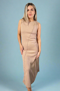 Model is wearing a taupe colored sleeveless maxi dress with exposed seam detailing. 
